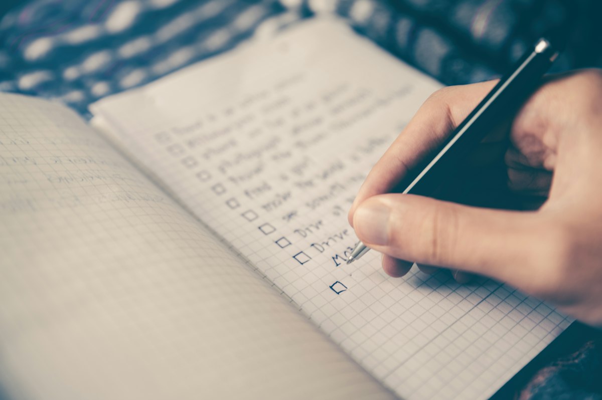 Open notebook with handwritten lists representing a personal action plan